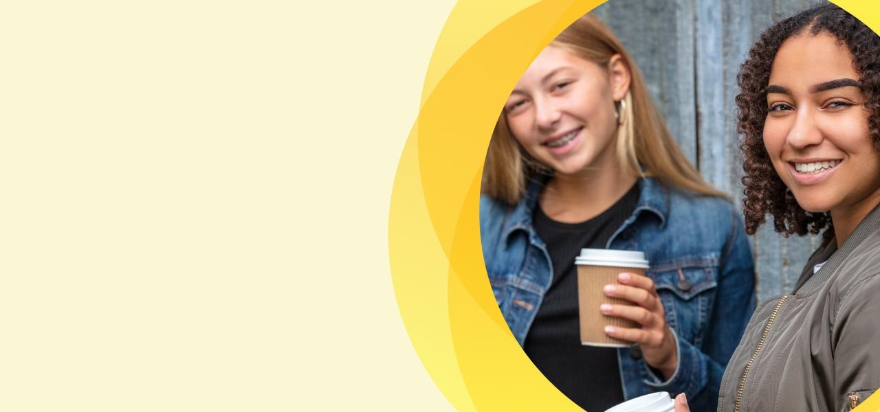 two girls smiling at camera